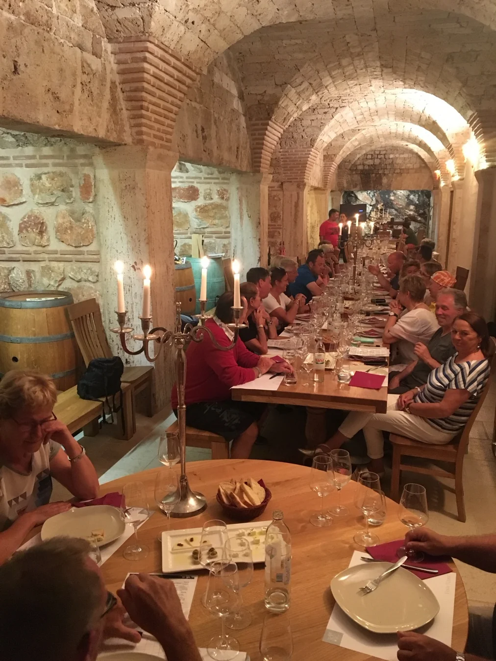 Guests dining together in a Croatian wine cellar