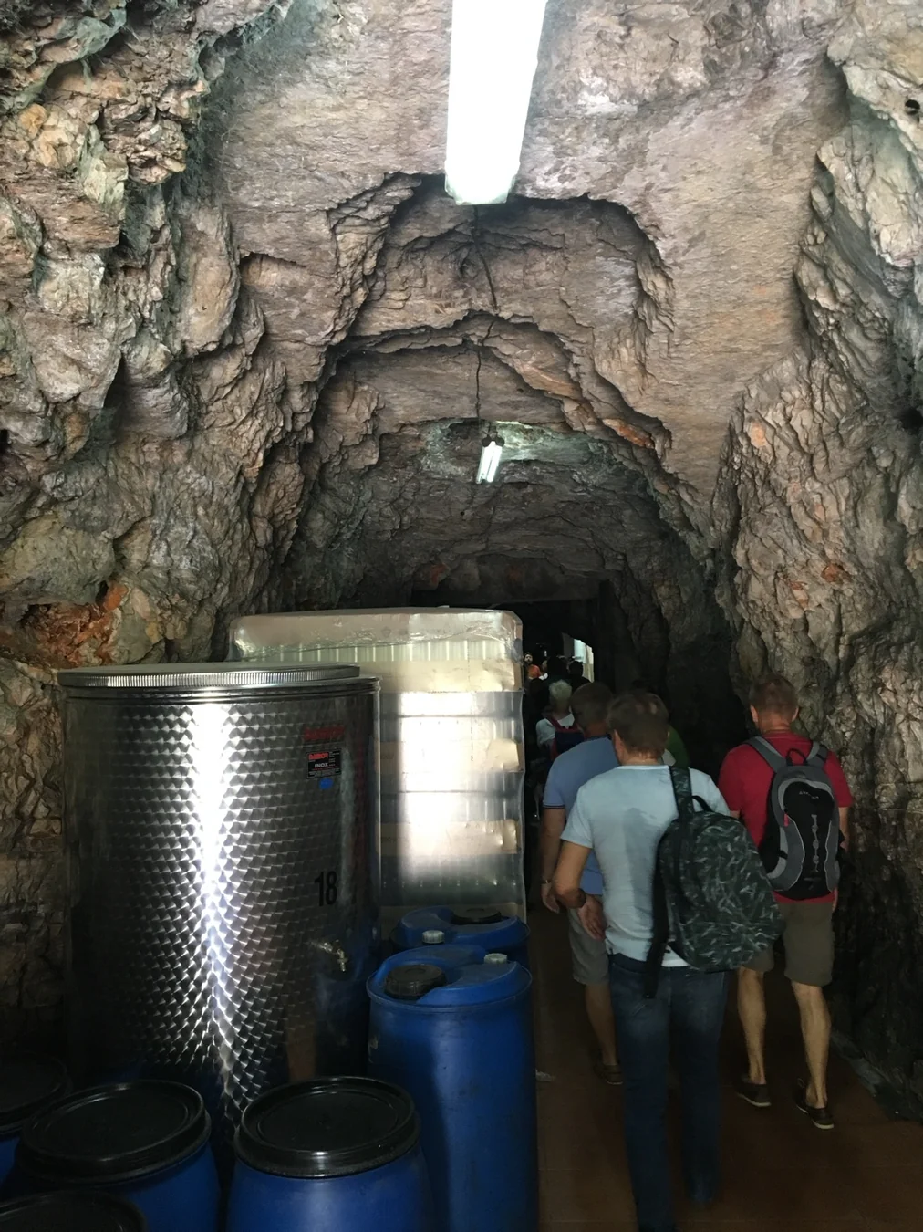 Guests visiting an underground Croatian wine cellar